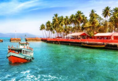 The Andaman and Nicobar Islands: A tropical paradise of turquoise waters, white sandy beaches fringed with coconut palms, vibrant coral reefs, and lush rainforests rich in biodiversity.