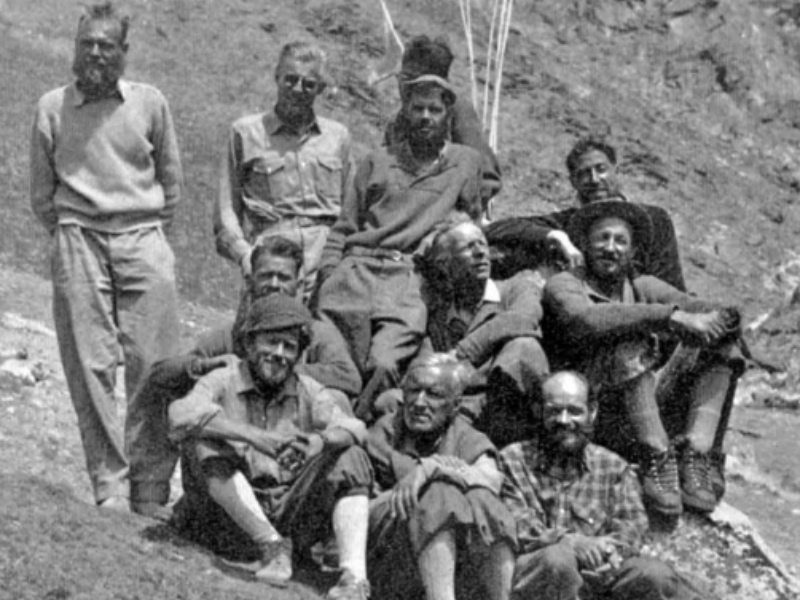 Group photo of the 1956 Swiss Lhotse Expedition team including Ernst Reiss, Fritz Luchsinger, Fritz Müller, and other Swiss climbers resting on a mountain slope during the first ascent of Lhotse.