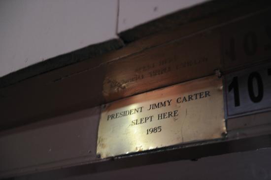 Brass plaque inside a mountain lodge reading “President Jimmy Carter slept here 1985,” marking the stay of the 39th U.S. president.