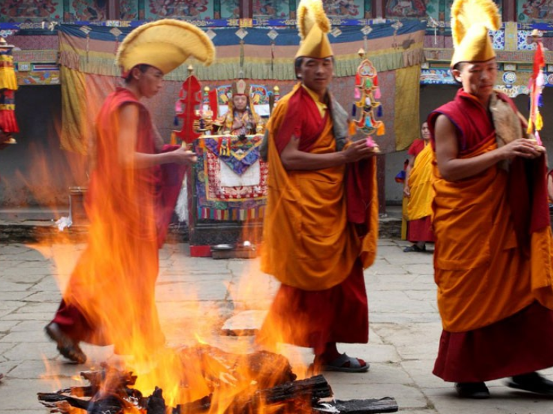 Monks perform the Fire Puja ceremony, offering prayers and butter to Agni, the god of fire, during the Mani Rimdu festival at Tengboche Monastery.
