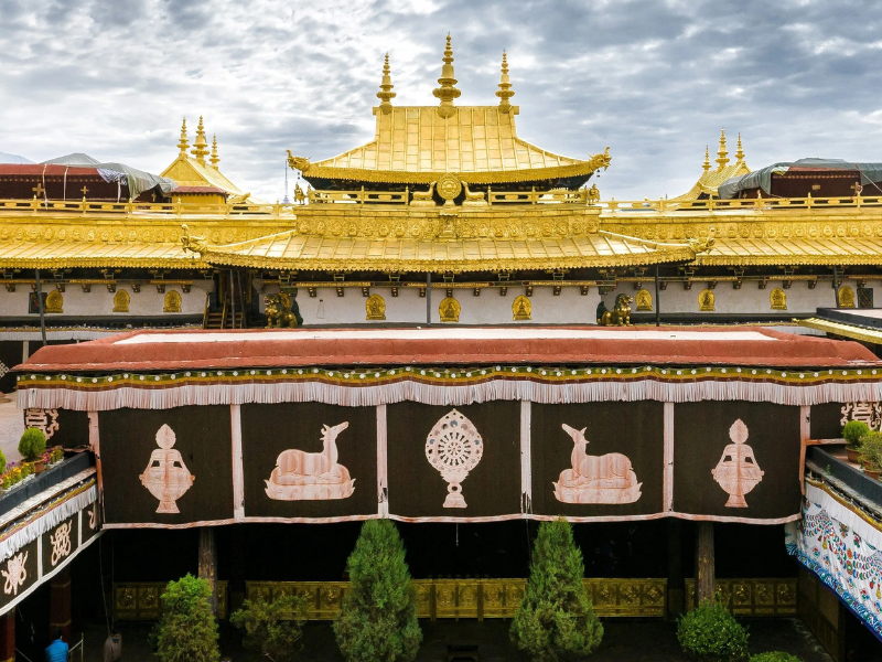 Jokhang Monastery in Lhasa, Tibet, founded in the 7th century by King Songtsen Gampo, featuring golden roofs and a sacred inner courtyard central to Tibetan Buddhism.