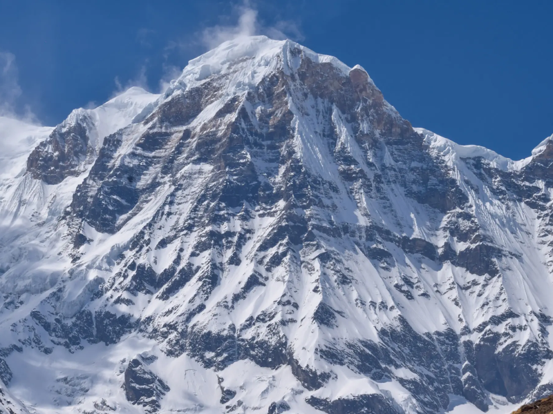 Close-up view of Annapurna Mountain, showcasing its snow-covered slopes and rugged terrain, taken from Camp II, Annapurna.
