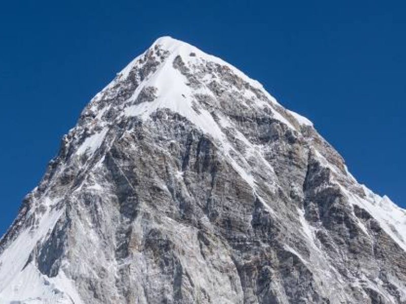 View of Mount Pumori next to Mount Everest, with a snow-covered peak, captured from the Everest Base Camp (EBC).