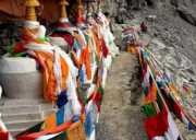 Prayer flags and chortens lining the narrow Saptarishi Cave path near Mount Kailash during the sacred parikrama route.