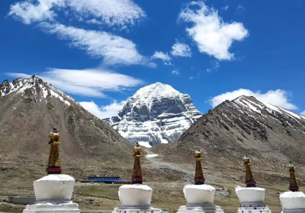 White chortens at Derapuk with Mount Kailash rising in the background under a clear blue Himalayan sky.