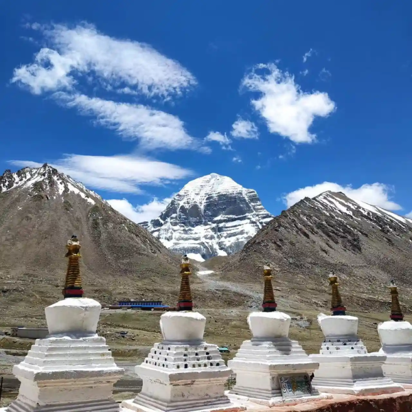 White chortens at Zuthulpuk with Mount Kailash rising in the background under a clear blue Himalayan sky.