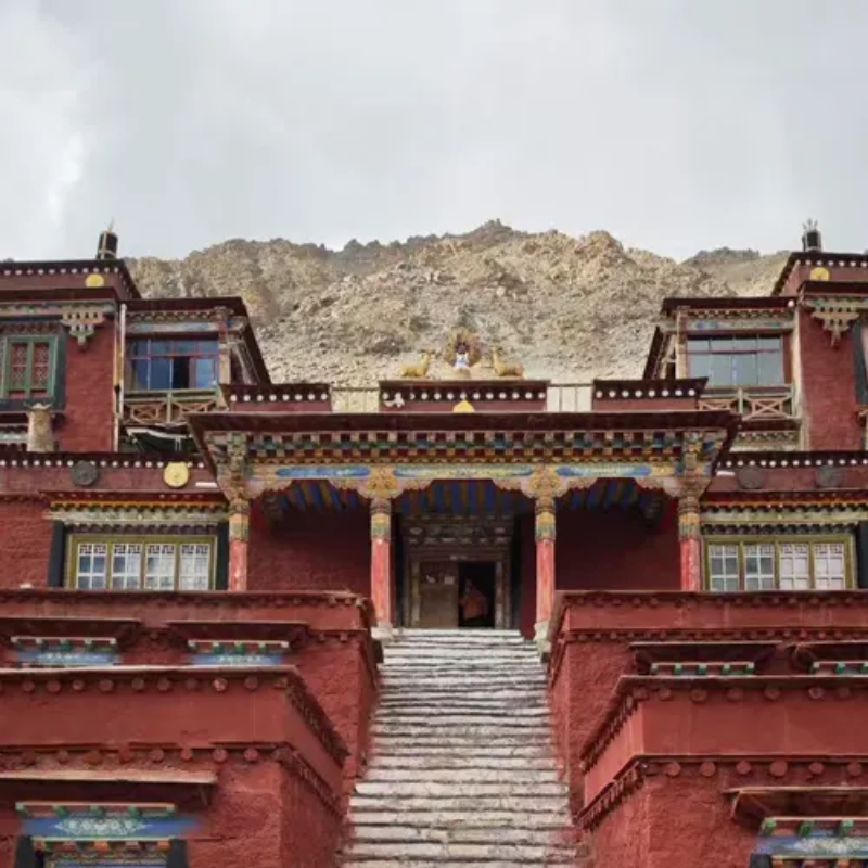 Derapuk Monastery with stone staircase and mountain backdrop near Mount Kailash