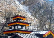 Muktinath temple complex surrounded by snowy hills during spring season