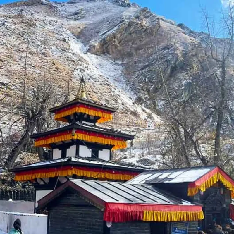 Muktinath temple complex surrounded by snowy hills during spring season