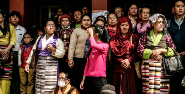 Sherpa community members gathered together wearing traditional Himalayan clothing