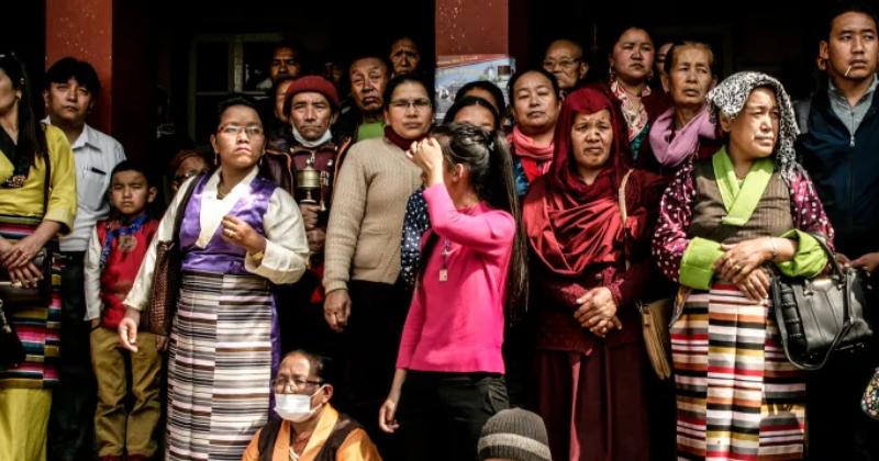 Sherpa community members gathered together wearing traditional Himalayan clothing