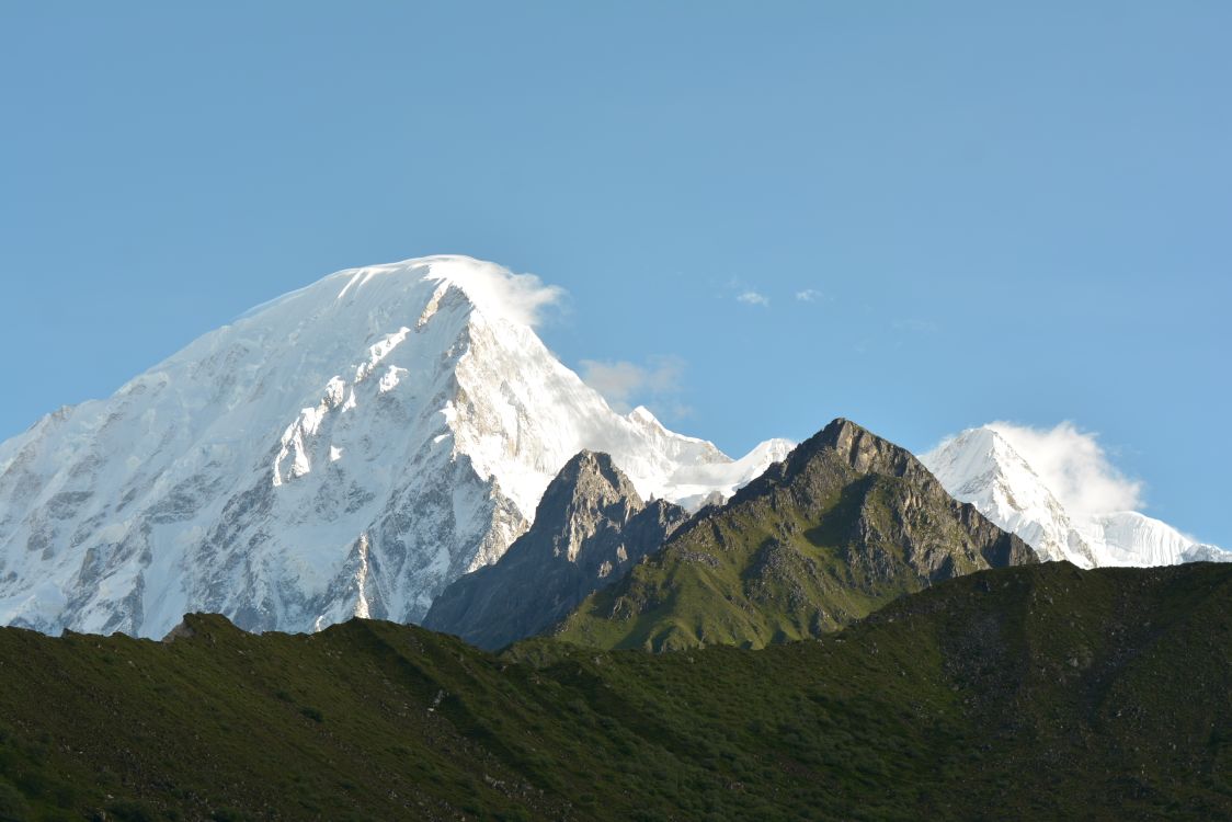 Snow-capped Himalayan peaks under a clear blue sky in Nepal