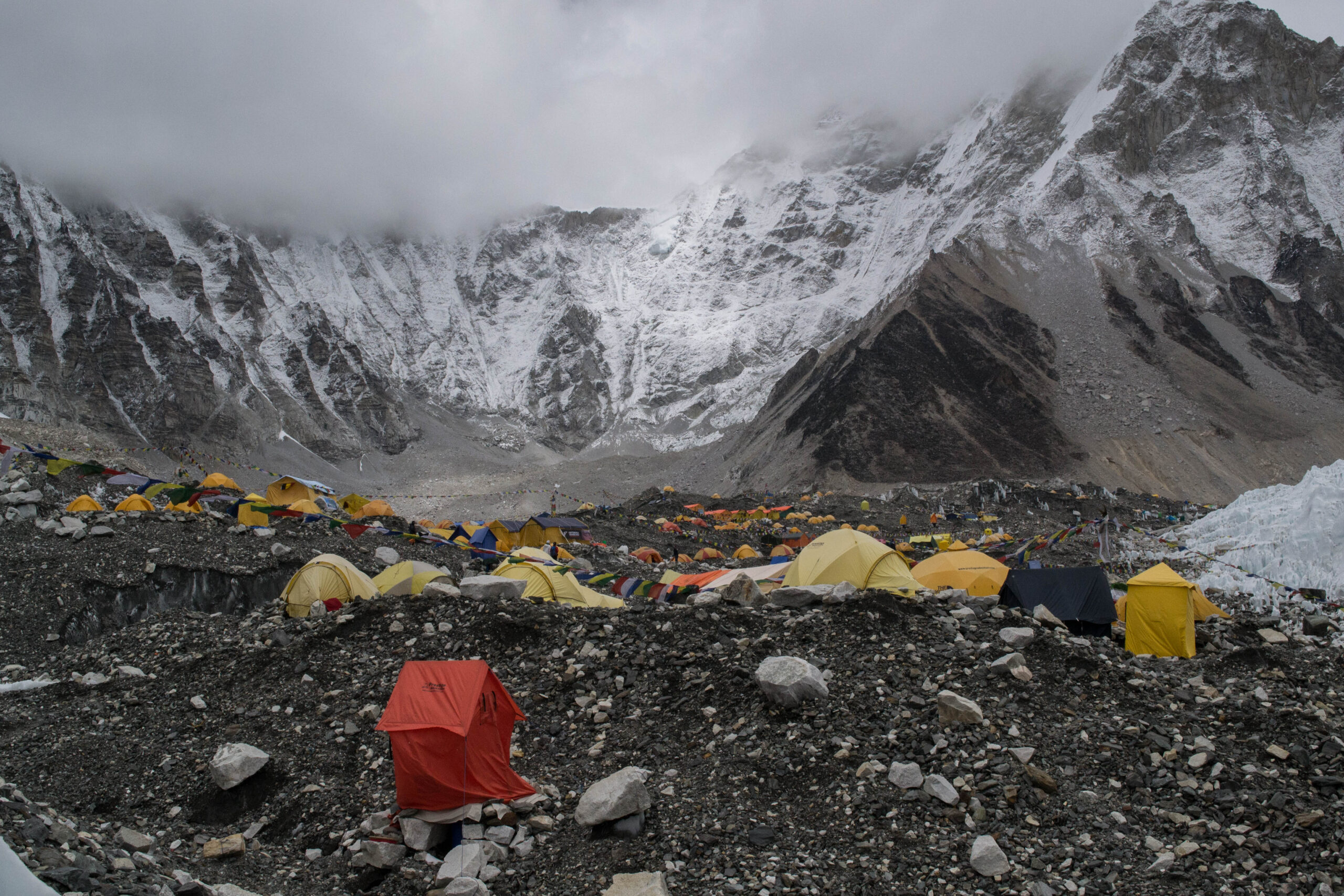 Tents and prayer flags at Everest Base Camp with Himalayan peaks behind